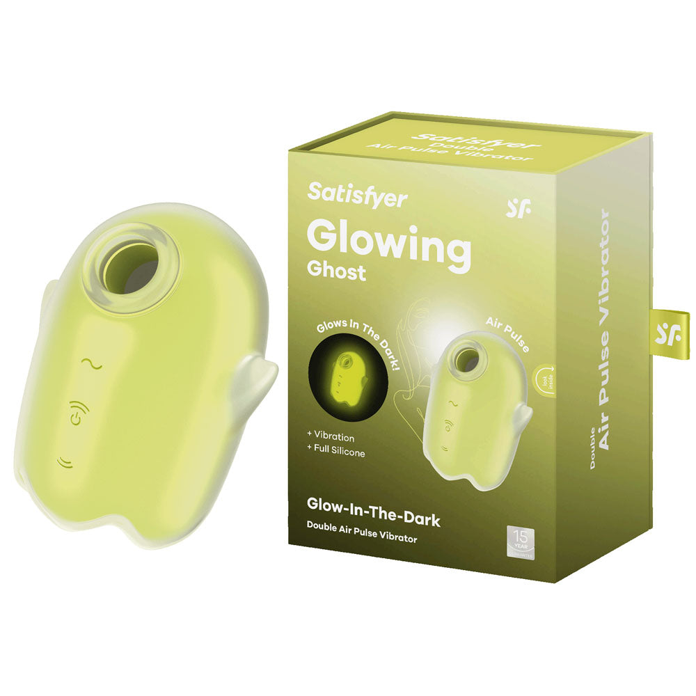 A yellow Satisfyer Glowing Ghost Air Pulse Vibrator is displayed next to its packaging. The packaging highlights features such as "vibration," "full silicone," and "double air pulse." The waterproof device has a compact, handheld design with control buttons.