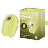 A yellow Satisfyer Glowing Ghost Air Pulse Vibrator is displayed next to its packaging. The packaging highlights features such as "vibration," "full silicone," and "double air pulse." The waterproof device has a compact, handheld design with control buttons.