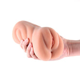 Hand holding a silicone vagina on a white background