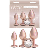 Rose gold metal plug kit with packaging labeled 'retar assets' on a white background.