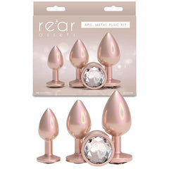 Rose gold metal plug kit with packaging labeled 'retar assets' on a white background.