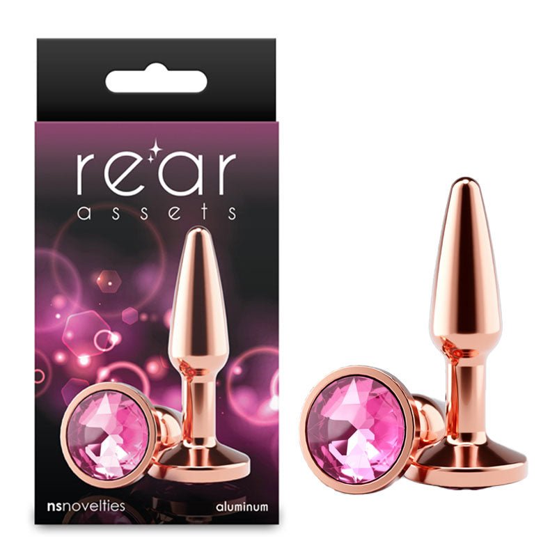 Rose gold butt plug with pink gemstones and 'rear assets' packaging on a white background
