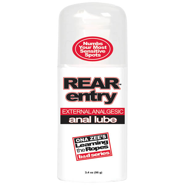 A bottle of "Ona Zee's Rear Entry" analgesic anal lube against a white background. The label states "Numbs Your Most Sensitive Spots" and includes the phrase "Learning the Ropes b&d series." Designed to desensitize rectal tissues, the bottle contains 3.4 oz (96 g).
