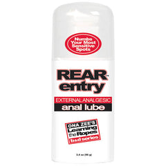 A bottle of "Ona Zee's Rear Entry" analgesic anal lube against a white background. The label states "Numbs Your Most Sensitive Spots" and includes the phrase "Learning the Ropes b&d series." Designed to desensitize rectal tissues, the bottle contains 3.4 oz (96 g).