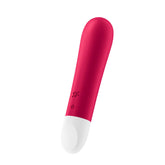 A vibrant pink and white cylindrical Satisfyer Ultra Power Bullet Vibrator 1 is displayed against a white background. Above the white power button are the letters "SV" near the device's center. The pleasure-inducing device is sleek with a smooth surface and rounded ends, epitomizing bullet vibes' elegant design.