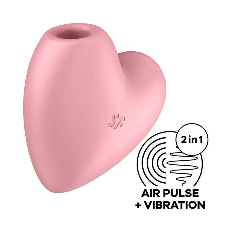 The Satisfyer Cutie Heart Air-Pulse Vibrator in light red is a heart-shaped device featuring a small circular opening at the top designed for clitoral stimulation. The right side of the image includes a graphic that reads "2 in 1" and "AIR PULSE + VIBRATION," accompanied by icons illustrating air pulse vibrators and vibration waves.