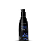 A black bottle of Wicked Aqua Blueberry Muffin Flavoured Water Based Lubricant - 60 ml. The front label showcases the brand name in silver text, the flavor name in blue text, and a blue muffin graphic at the bottom. The bottle is topped with a sleek black pump.