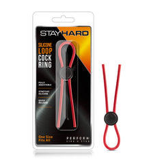 Packaging of the Stay Hard - Silicone Loop Cock Ring. The package displays a red, body-safe silicone loop accompanied by a black adjustable slider. Text on the packaging emphasizes features such as "fully adjustable," "stretchy silicone," "quick release," and "one size fits all.