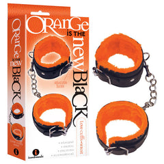 Image depicting the "Orange Is The New Black - Love Cuffs - Wrist - Black Fluffy Wrist Restraints." The cuffs are black with an orange lining, connected by strong chains and equipped with sturdy metal buckles. The packaging mirrors this design, showcasing the product name along with descriptions such as "elegant," "erotic," "exciting," and "economical.