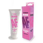 A tube and box of "Numb AF - Strawberry Oral Desensitiser." The white tube with bold pink text displays the product name and flavor. The matching pink box features the same information. Labels indicate it is suitable for all kinds of oral use and contains 1.5 oz (44 ml).