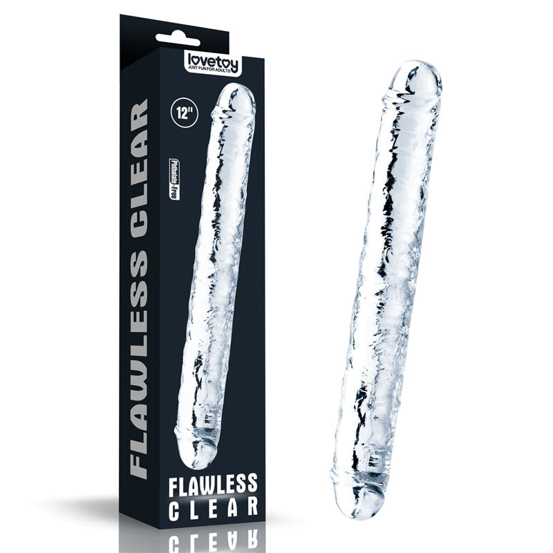 The image displays a transparent Flawless Clear Double Dildo from Lovetoy, featuring a textured surface. The packaging, predominantly black with white text, confirms the product's 12-inch length and highlights its composition of skin-safe TPE for a safe experience.