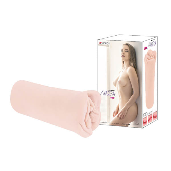 The Kokos Mini Nara, a cylindrical adult toy in light pink, is displayed next to its packaging box. The box showcases an image of a nude woman with long hair standing sideways. This product is designed to enhance sexual excitement with its realistic feel.