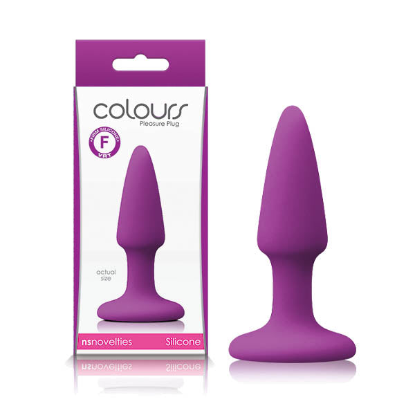 A purple silicone anal plug with a satin smooth finish is displayed beside its packaging. The predominantly white and purple box features the product name "Colours Pleasures Butt Plug - Purple." Made by "nsnovelties," it states that the material is platinum silicone and includes a convenient suction cup base.