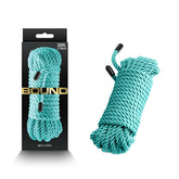The image showcases a green-colored braided rope from "Bound," measuring 7.6 meters (25 feet) in length, displayed alongside its black packaging box labeled "Bound." The comfortable rope is neatly coiled, with the ends secured by black plastic caps.