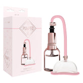 Packaging and product of the "Pumped Pussy Pump - Rose Pink Vagina Pussy Pump" are shown. The vaginal pump features a clear suction cup with a soft pink silicone edge, connected to a hand-operated pump by a pink tube. Designed to enhance blood flow and increased sensitivity, the packaging showcases a geometric design with the brand name "Pumped" prominently displayed.