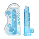 A transparent blue dildo, featuring a realistic shape and lifelike balls, along with a suction cup base, is displayed next to its packaging. The packaging reads "RealRock 8'' Realistic Dildo With Balls - Blue Dong" and notes that the product is 8 inches (19 cm) long, latex and phthalate free.