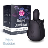 Packaging and product of a "Skins Rose Buddies - The Bums N Roses" personal massager. The black, rosebud-shaped vibrating anal toy features a small elongated top. The background packaging displays the brand "Skins," highlighting its vibration settings, noise reduction, water resistance, and more. Look for the "Rose Buddies" logo in the bottom-left corner.