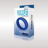 A blue Zolo Extra Thick Silicone Cock Ring is shown in its packaging. The box is white with blue accents, showcasing an image of the product and highlighting its benefits, such as ultra toughness, stronger erections, and size enhancement. A gradient grey background completes the display.