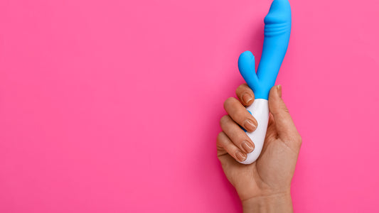 Rabbit Vibrator - Blue in colour being held by a hand