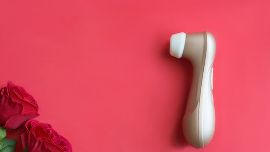 Satisfyer clit sucking vibrator on red back ground