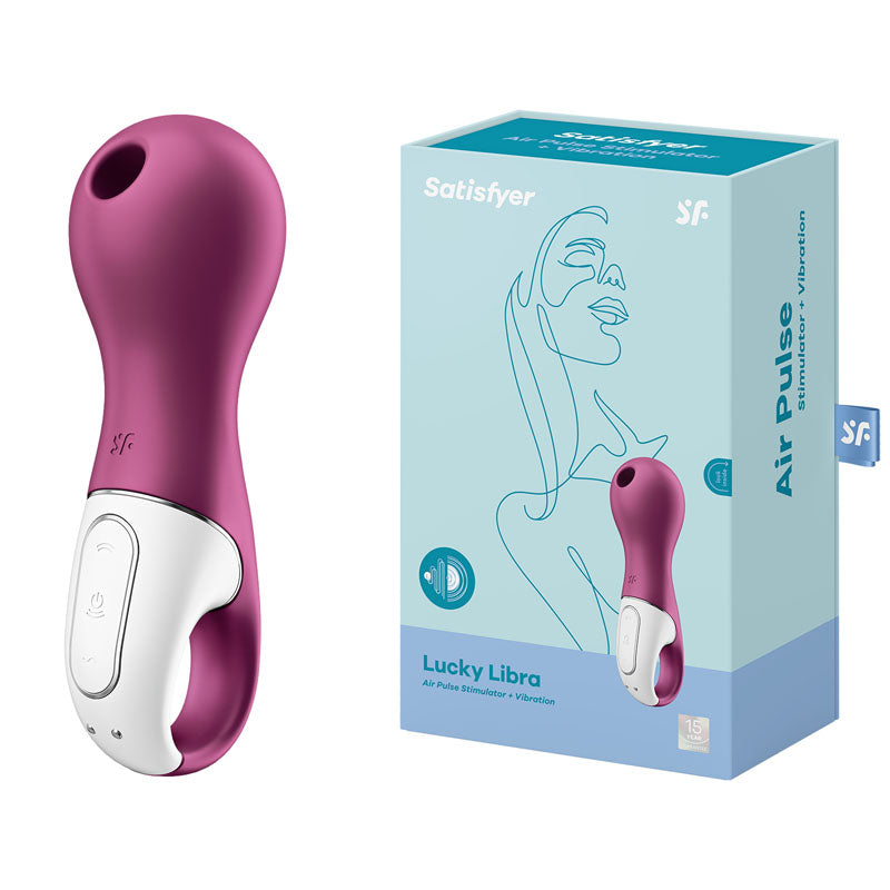 A berry red Satisfyer Lucky Libra Air Pulsation Stimulator with Vibration is showcased next to its teal and pink packaging box. The minimalist design on the box highlights a woman's profile and details like "air pulse + vibration," emphasizing the body-friendly silicone used in its construction.