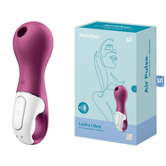 A berry red Satisfyer Lucky Libra Air Pulsation Stimulator with Vibration is showcased next to its teal and pink packaging box. The minimalist design on the box highlights a woman's profile and details like "air pulse + vibration," emphasizing the body-friendly silicone used in its construction.