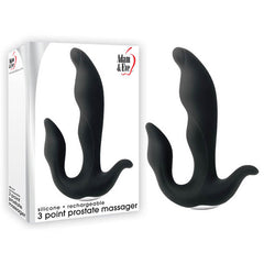Box and product of the Adam & Eve 3-Point Prostate Massager. The ergonomic design features a black, triple-pronged shape and offers 10 unique speeds and functions. The box showcases the massager alongside the brand name in striking red and black text.