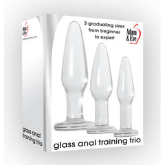 The image depicts the "Adam & Eve Glass Anal Training Butt Plug Trio" boxed set, featuring three glass anal plugs in varying sizes. The packaging highlights "3 graduating sizes from beginner to expert," making it ideal for pelvic floor training and personal exploration at your own comfort level.
