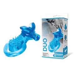 The Rechargeable Duo Cock Ring with Clit Tickler, designed in blue silicone and featuring a textured surface, is displayed next to its packaging. The box showcases an image of the product and highlights key features such as 10 powerful vibrations, a rechargeable bullet vibe, and body-safe material, making it an ideal couples toy.