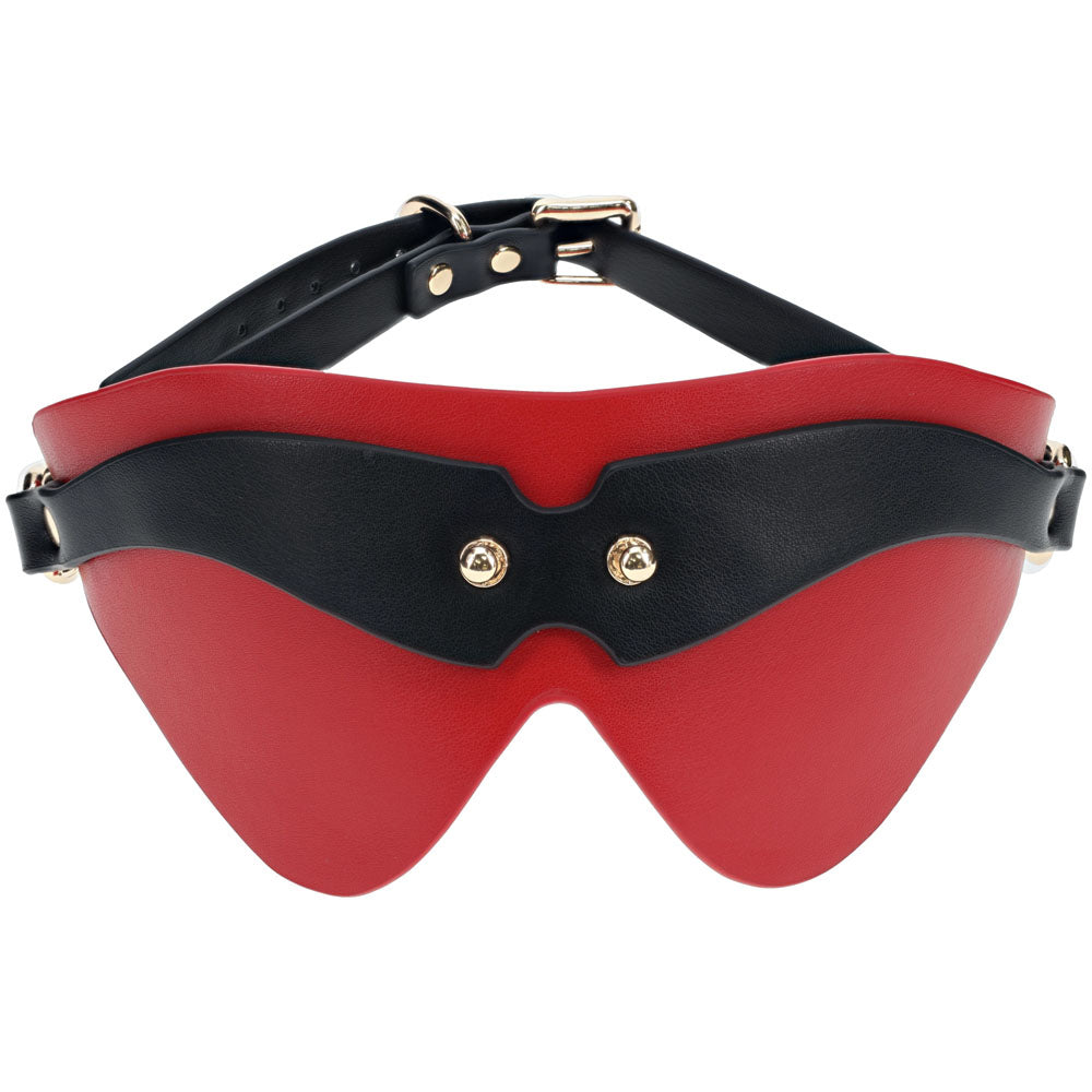 The OUCH! Milan Collection - Blindfold features a sleek, curved design in black and red bonded leather. It fits comfortably over the eyes, secured by an adjustable strap with metal buckles. Two metallic rivets on the front add a touch of high-fashion elegance.