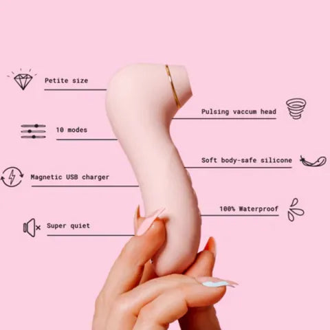 Hand holding a vacuum cleaner with features listed on a pink background