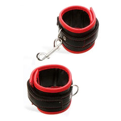 Black and red wrist cuffs with a carabiner on a white background