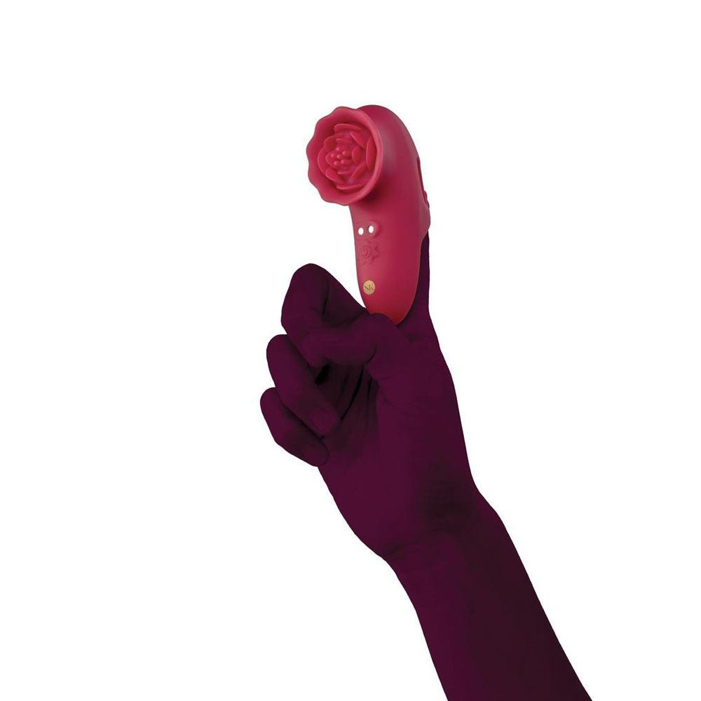 Hand wearing a dark purple glove holding a red phone receiver on a white background
