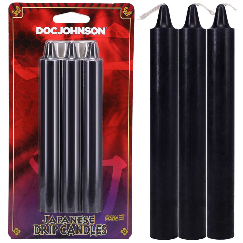 A packaged set of three black Japanese Drip Candles - Black by DOC JOHNSON, made from non-toxic wax, is shown. Beside the package, three loose black candles stand upright in a close-up, perfect for hot wax play.