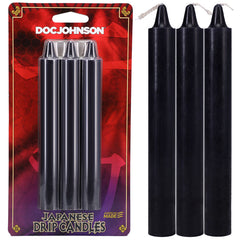 A packaged set of three black Japanese Drip Candles - Black by DOC JOHNSON, made from non-toxic wax, is shown. Beside the package, three loose black candles stand upright in a close-up, perfect for hot wax play.