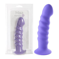 The Maia Kendall is a luxurious purple silicone dong featuring a wavy, ribbed texture and a strong suction base. Made from medical-grade silicone, this dildo is displayed inside clear packaging labeled "Maia Kendall" as well as showcased on its own next to the packaging.