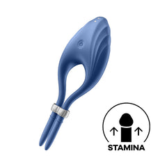The Satisfyer Duelist Vibrating Cock Ring is a blue, shell-shaped wearable sex toy made from silicone, featuring a central circular button and two prongs. Accompanied by an illustrative icon indicating improved stamina and a graphic with an upward arrow next to the word "STAMINA," this device also includes an adjustable penis ring for enhanced performance.
