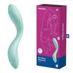 A Satisfyer Rrrolling Pleasure G-spot vibrator - Mint is displayed beside its packaging, which showcases an abstract line drawing of a face along with the product name and branding. The vibrator boasts a smooth, curved design that promises sensual vibrations.