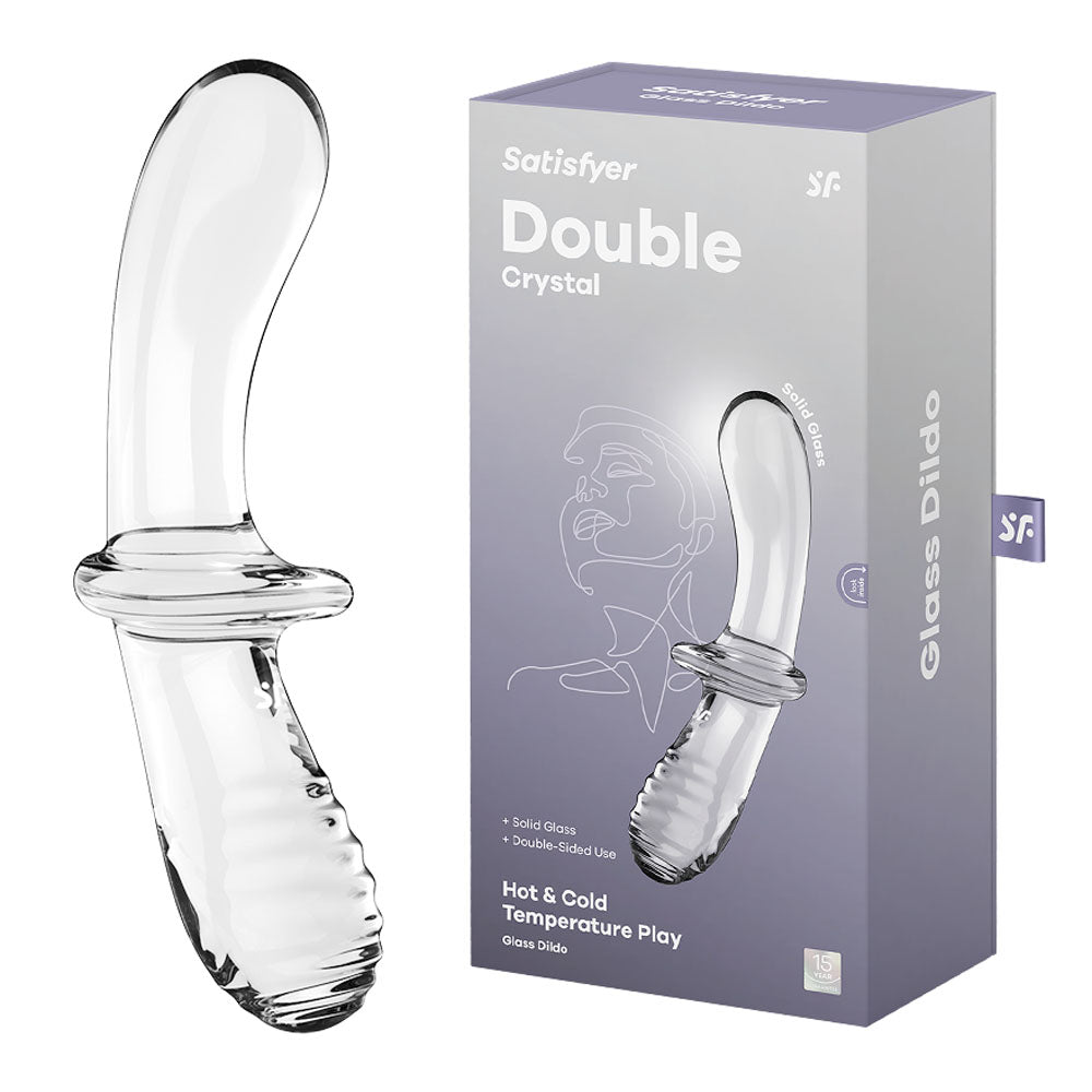 The image features a glass dildo named "Satisfyer Double Crystal Glass Dildo" displayed alongside its packaging. The clear dildo boasts a curved, smooth texture with ridges at the base. The packaging highlights features like "Solid Glass," "Double-sided Use," and "Hot & Cold Temperature Play.