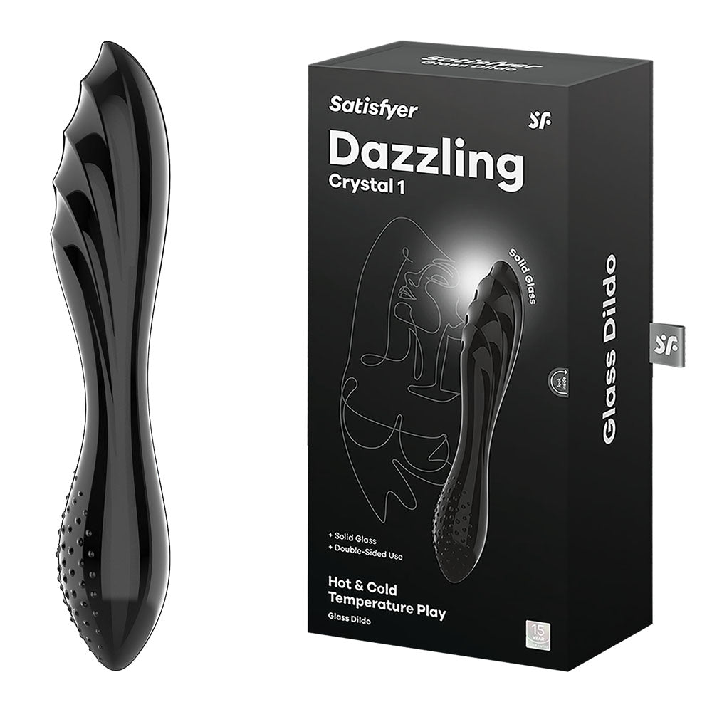 A black glass dildo with a contoured, textured design, known as the Satisfyer Dazzling Crystal 1 Glass Dildo - Black, is displayed next to its packaging. The box highlights features such as "solid glass," "double-ended use," and "Hot & Cold Temperature Play.