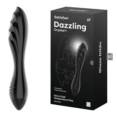 A black glass dildo with a contoured, textured design, known as the Satisfyer Dazzling Crystal 1 Glass Dildo - Black, is displayed next to its packaging. The box highlights features such as "solid glass," "double-ended use," and "Hot & Cold Temperature Play.