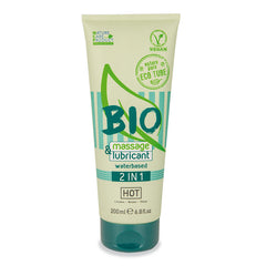 A 200 ml (6.8 fl. oz) green and beige tube of HOT BIO Massage & Lubricant 2In1, labeled as vegan, water-based, and designed to protect against vaginal dryness. The packaging highlights "Nature Care Product" and "Eco Tube," with logos and text identifying its “Hot” variant.