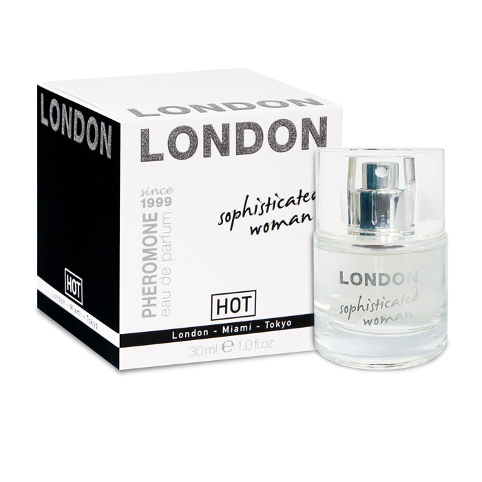 A clear perfume bottle labeled "Hot Pheromone London - Sophisticated Woman" sits beside a matching box. Text on the box highlights "since 1999," "PHEROMONE eau de parfum," and the cities "London, Miami, Tokyo." The 30ml bottle of this enticing scent is known for its aphrodisiac qualities.