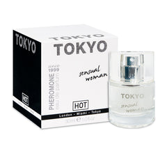 A 30ml bottle of Hot Pheromone Tokyo - Sensual Woman - Pheromone Perfume for Women, known for its sexual attractants, is displayed next to its black and white packaging box. The box features bold "TOKYO" text at the top and "HOT" brand details. The transparent perfume bottle has a silver cap with similar text on its label.