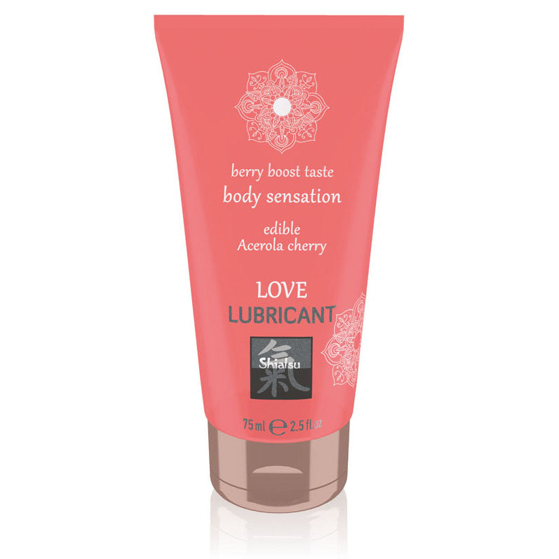 A pink tube of SHIATSU Love Cherry Water-based Lubricant with the brand's logo and product information displayed