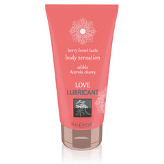 A pink tube of SHIATSU Love Cherry Water-based Lubricant with the brand's logo and product information displayed
