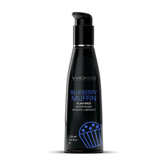The "Wicked Aqua Blueberry Muffin Flavoured Water Based Lubricant" is an ideal choice for boosting oral pleasures. This 120 ml (4.0 fl oz) lubricant comes in a sleek black bottle equipped with a convenient pump dispenser, adorned with blue and white text and a tantalizing muffin image.