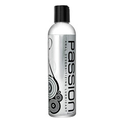 Bottle of Passion Anal Desensitising Lubricant with a black cap and a label featuring white and black swirls and text.