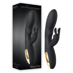 A sleek, black silicone rabbit vibrator named "The Midnight Rabbit" by Adam & Eve, featuring a curved main shaft and a smaller clitoral stimulator with dual motors for heightened pleasure. The product is displayed next to its packaging, which prominently showcases the same vibrator along with the "Adam & Eve" branding.