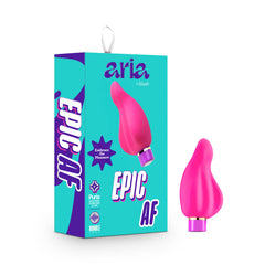 The image depicts a pink, uniquely-shaped Aria Epic AF Vibrator placed beside its turquoise and purple packaging box. The box is labeled "Aria Epic AF" and "EPIC AF," and highlights features such as a "Rumble Tech Motor," an "IPX7 waterproof" rating, and a label indicating it is made of "Pure Platinum Cured Silicone + Infrared Warming.